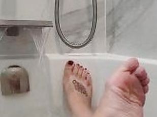 Beautiful wet feet in the bath