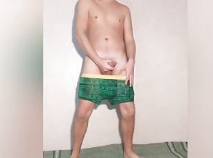A young hot guy poses in underwear and takes off his green panties - boxers showing his dick and ass