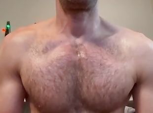 Hot and hairy man grease himself up with lotion