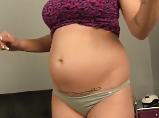 Pregnant lady posing solo and showing off her big sexy belly