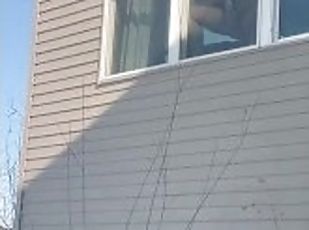 Public Masturbation: sexy horny MILF gets caught by neighbors masturbating in window with big dildo.