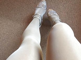 Leg tease in layerd shiny white crystal pantyhose and bright high heels.