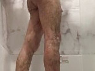 Hot guy cleans himself in the shower.